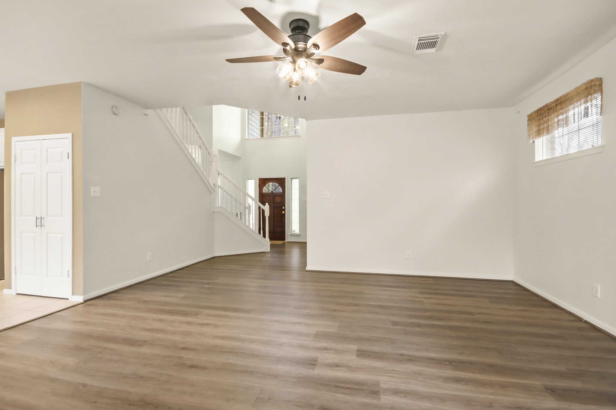 111 South Dreamweaver Circle Spring, TX 77380 - Photo 4 of 30 a view of an empty room with window and wooden floor