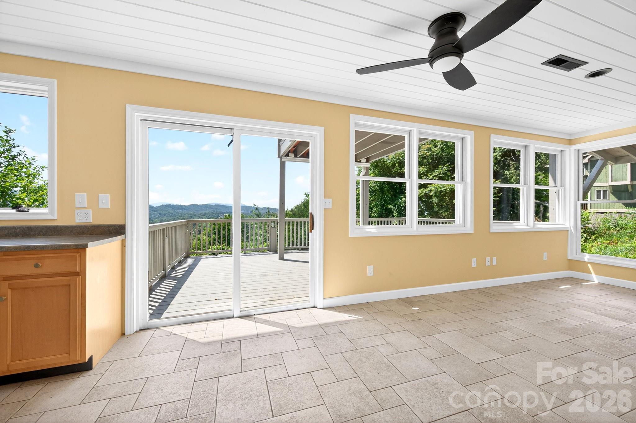 38 Lookout Road Asheville, NC 28804 - Photo 30 of 34 a view of an empty room with a window and a ceiling fan
