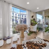 a room with potted plants and a dining table