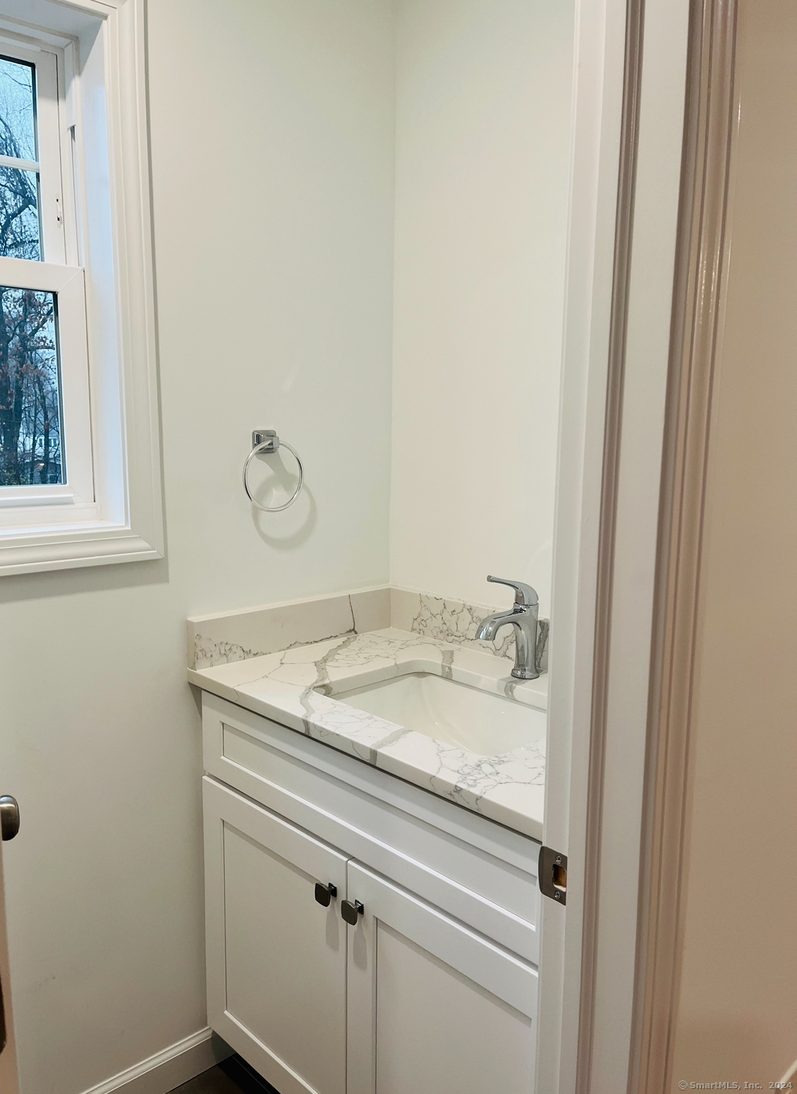 14 Infield Street Bridgeport, CT 06606 - Photo 3 of 8 a bathroom with a granite countertop sink and vanity