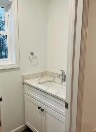 a bathroom with a granite countertop sink and vanity