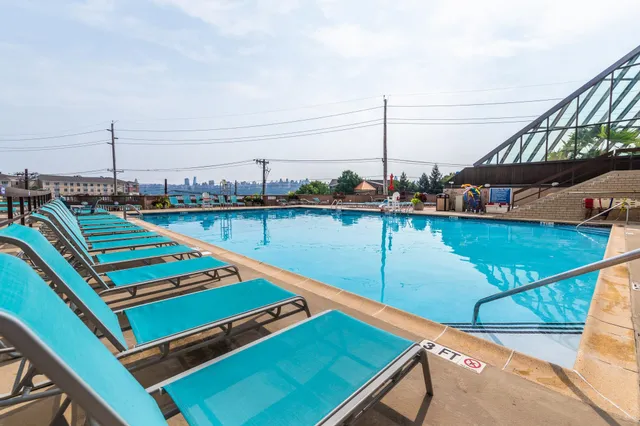 a view of a balcony with chairs and wooden floor