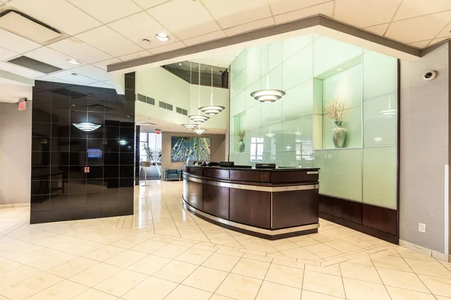 a view of living room and kitchen with stainless steel appliances
