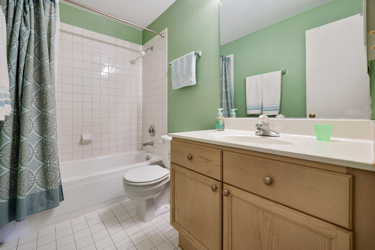 815 Leicester Road, Unit 114A Elk Grove Village, IL 60007 - Photo 19 of 20 a bathroom with a double vanity sink toilet and shower