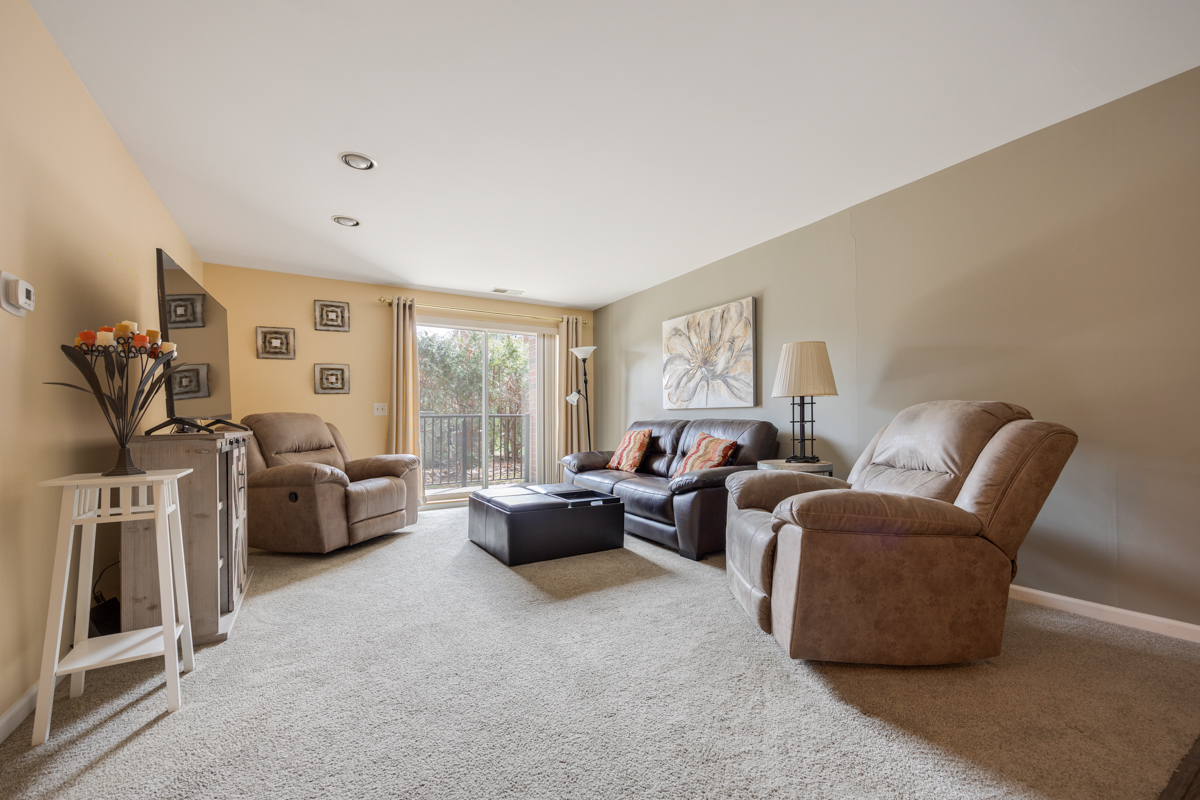 815 Leicester Road, Unit 114A Elk Grove Village, IL 60007 - Photo 5 of 20 a living room with furniture and a large window