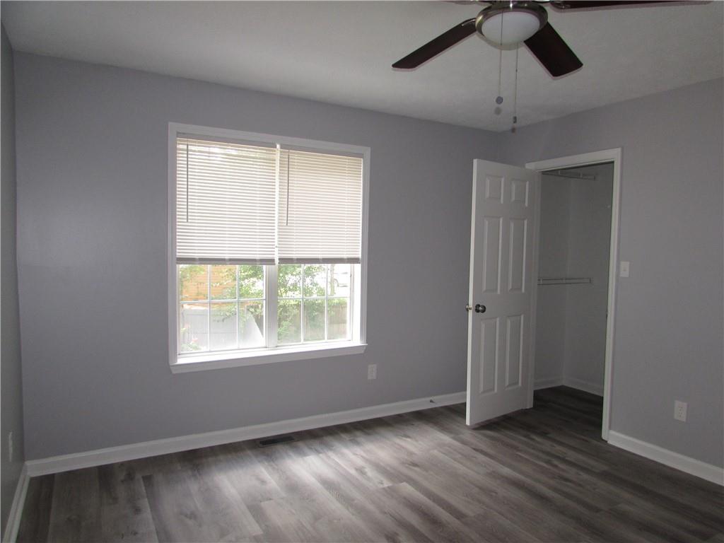 835 Heritage Valley Road Norcross, GA 30093 - Photo 28 of 34 a view of an empty room with wooden floor and a window