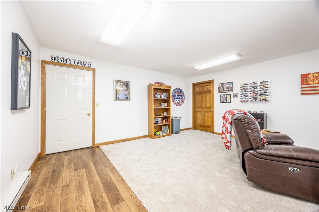 1602 Glendale Road, Unit 3 Marietta, OH 45750 - Photo 34 of 49 Lower level finished room featuring wood-finish flooring transitioning to plush carpeting