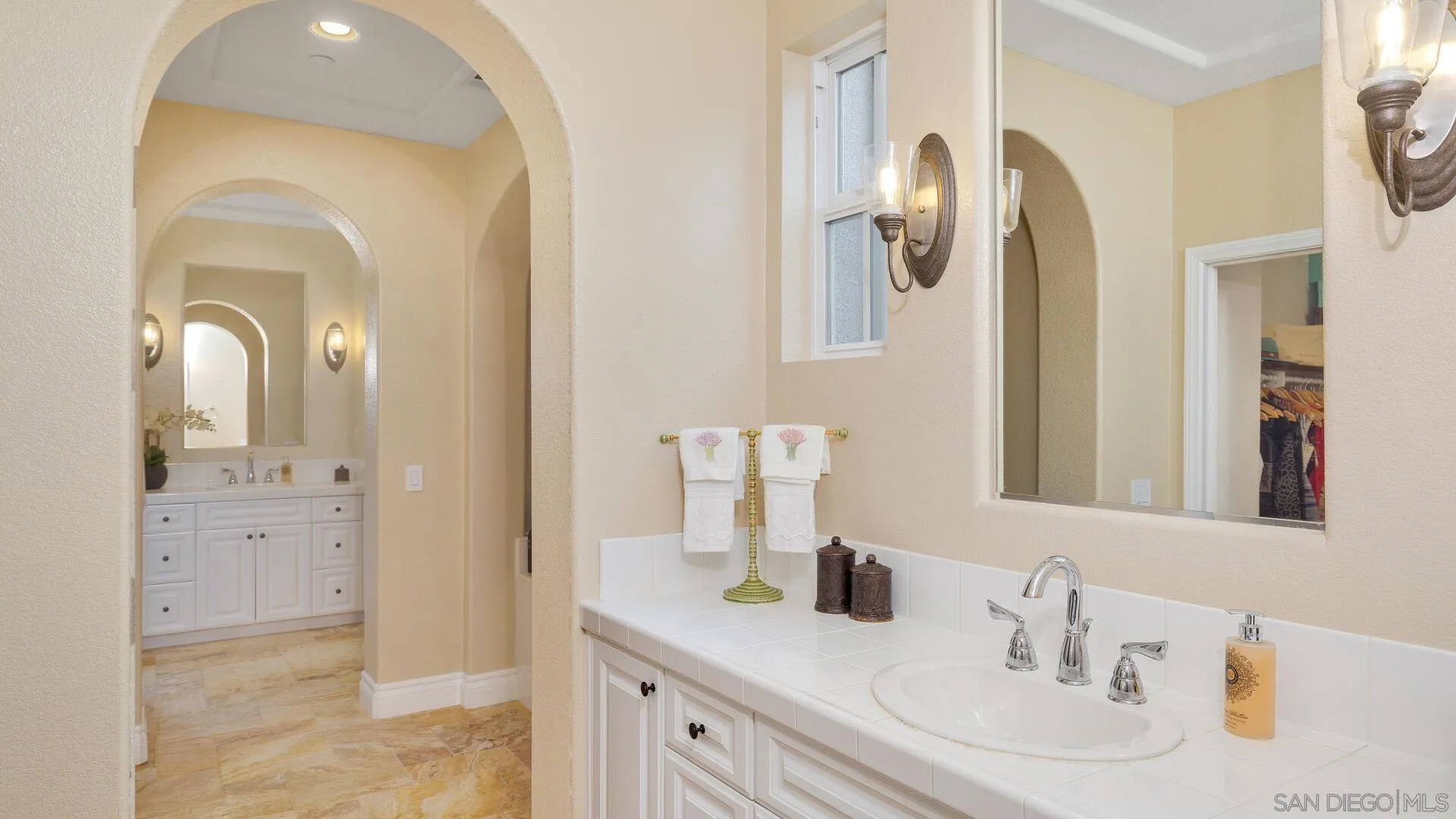 694 Rihely Place Encinitas, CA 92024 - Photo 16 of 31 a bathroom with a sink vanity and mirror