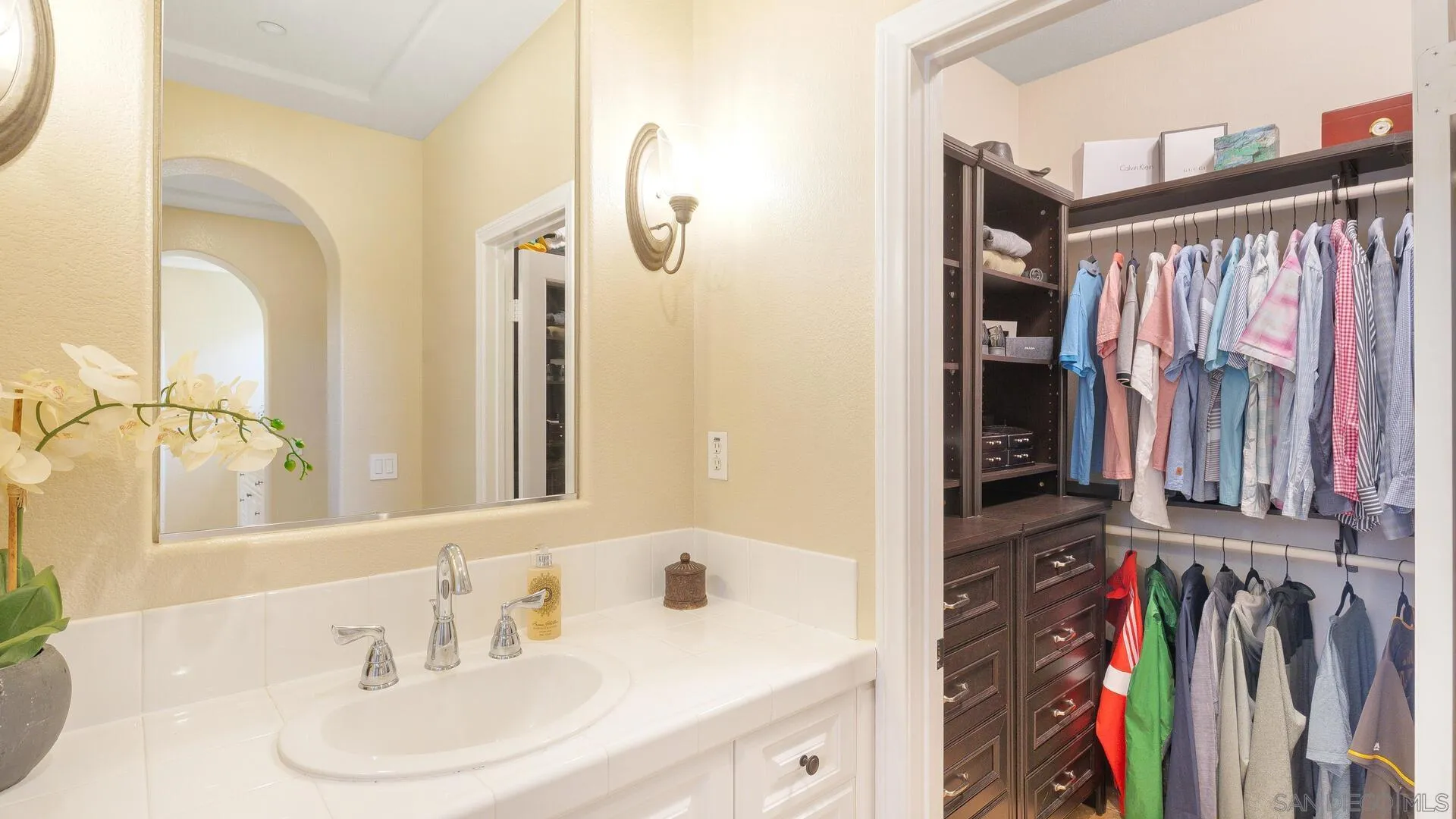 694 Rihely Place Encinitas, CA 92024 - Photo 18 of 31 a view of a bathroom with a sink and a mirror