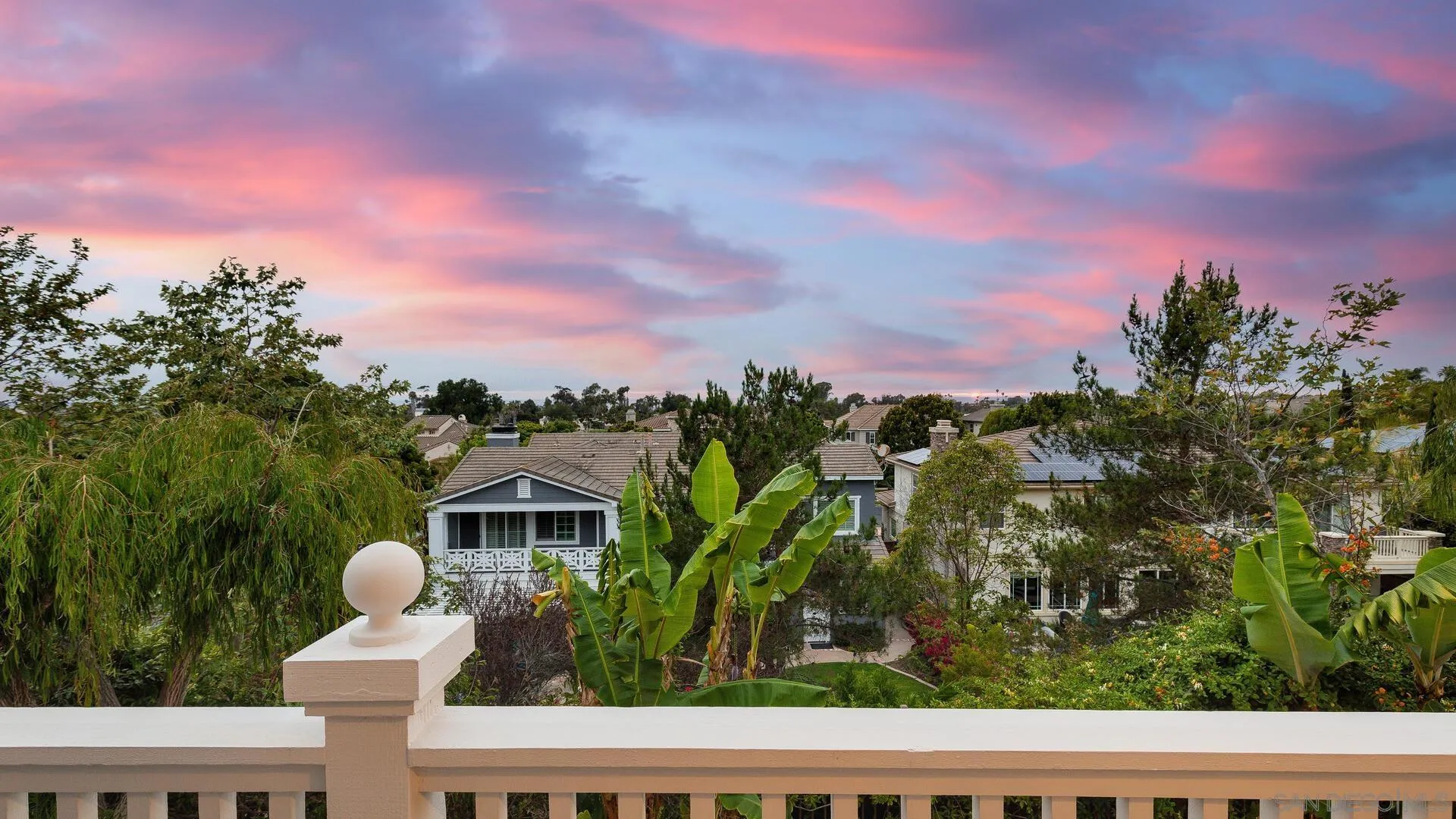 694 Rihely Place Encinitas, CA 92024 - Photo 26 of 31 a view of a white house with a swimming pool and garden in the back