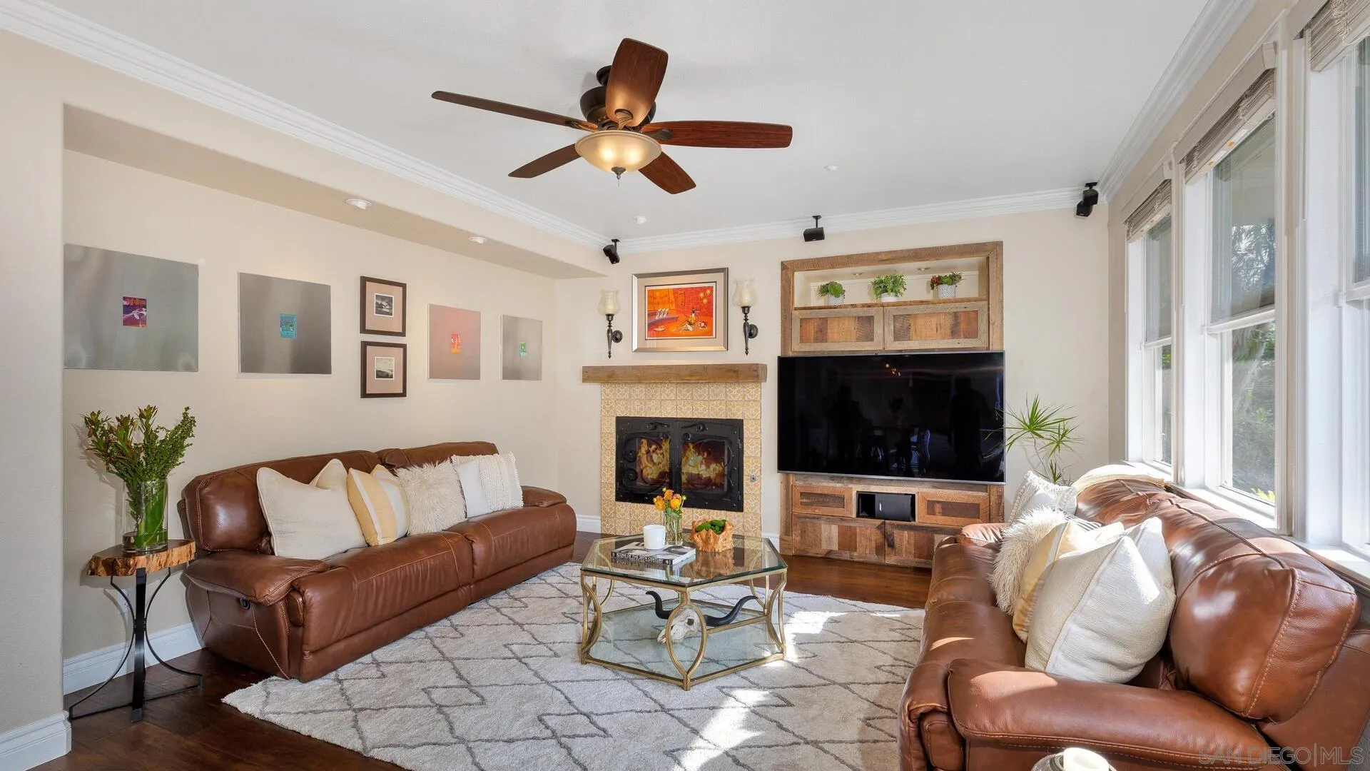 694 Rihely Place Encinitas, CA 92024 - Photo 4 of 31 a living room with furniture flat screen tv and a fireplace