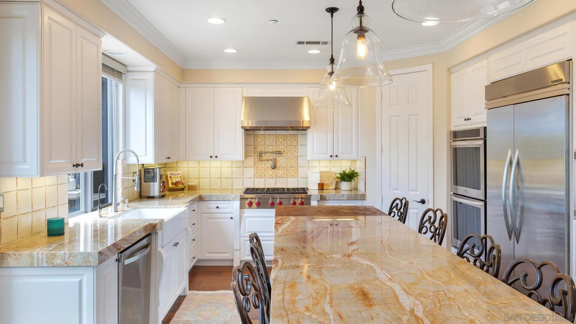694 Rihely Place Encinitas, CA 92024 - Photo 8 of 31 a spacious kitchen with stainless steel appliances granite countertop a sink refrigerator and cabinets
