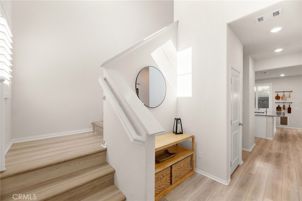 36362 Arcs Street Winchester, CA 92596 - Photo 11 of 54 a view of a hallway with entryway wooden floor and front door
