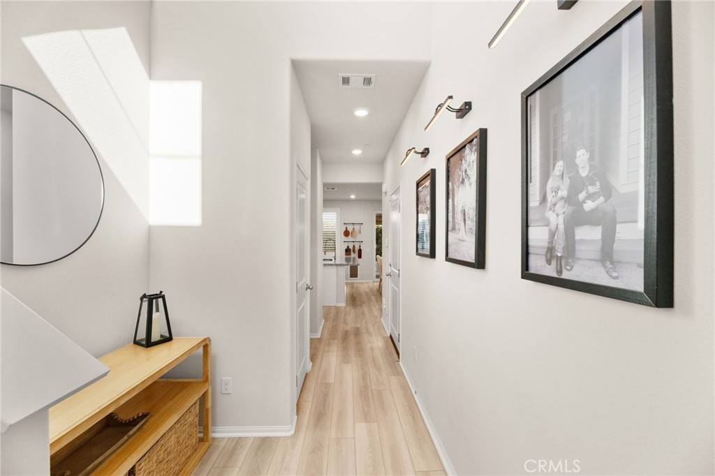 36362 Arcs Street Winchester, CA 92596 - Photo 12 of 54 a view of a hallway with paintings on the wall