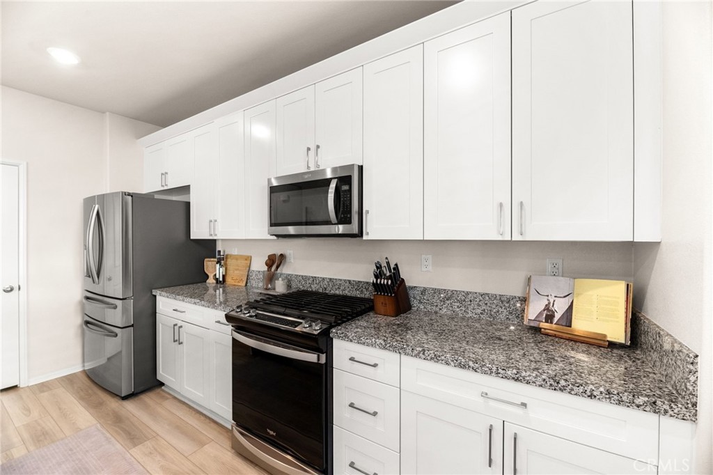 36362 Arcs Street Winchester, CA 92596 - Photo 16 of 54 a kitchen with appliances a sink and cabinets