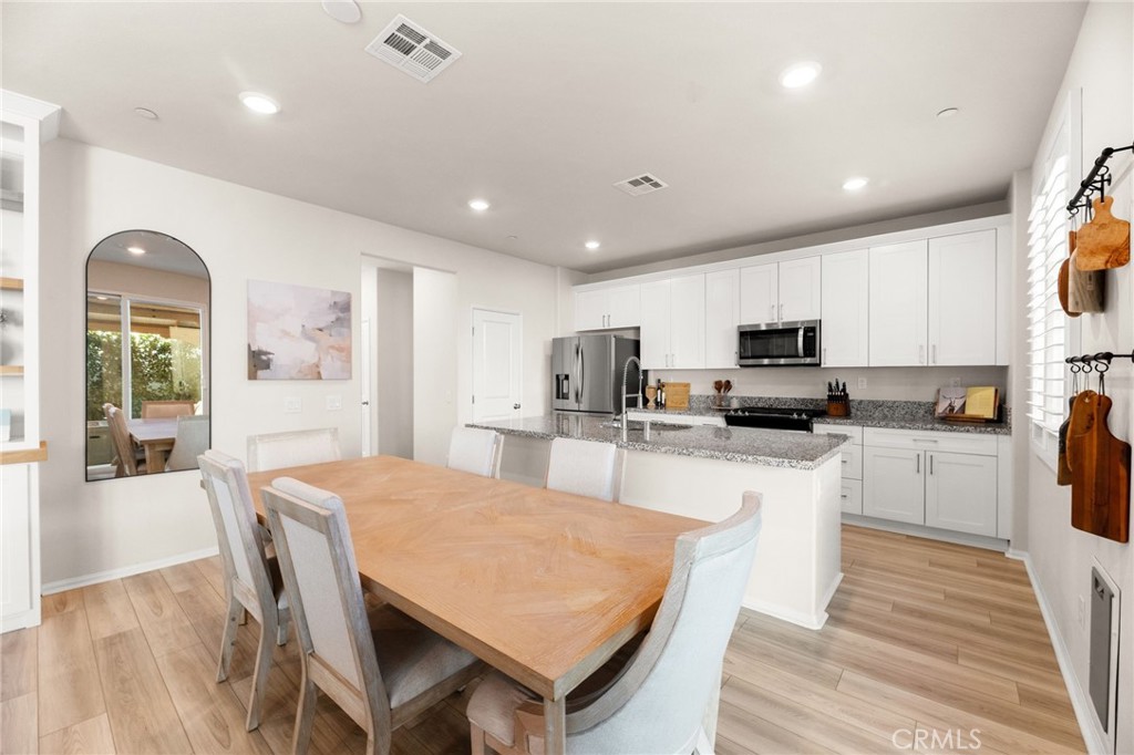 36362 Arcs Street Winchester, CA 92596 - Photo 22 of 54 a large kitchen with sink a center island and stainless steel appliances