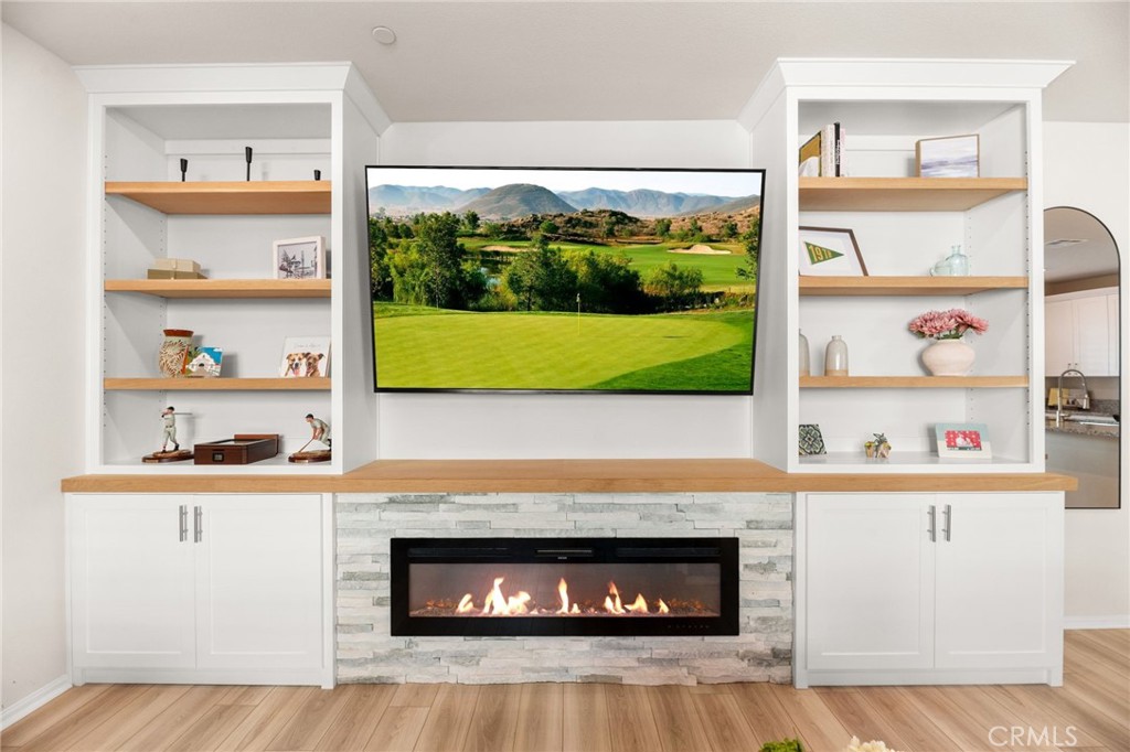 36362 Arcs Street Winchester, CA 92596 - Photo 25 of 54 a room with a fireplace and a floor to ceiling window