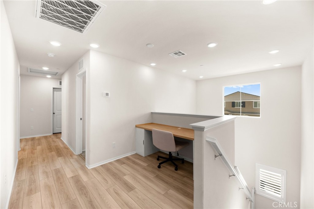 36362 Arcs Street Winchester, CA 92596 - Photo 30 of 54 a workspace with wooden floor and furniture