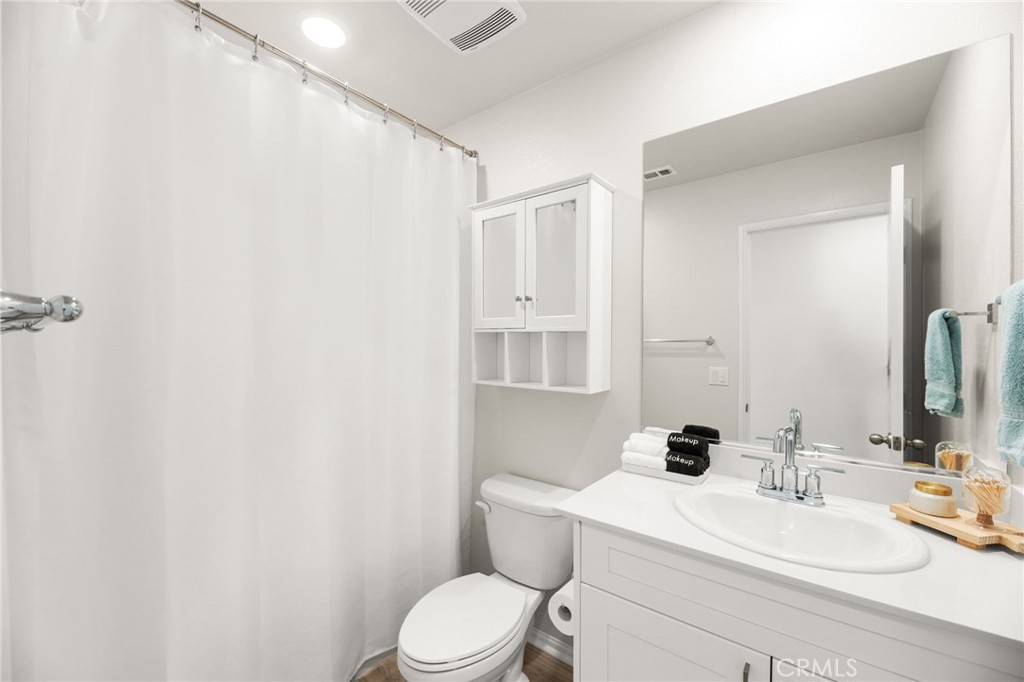 36362 Arcs Street Winchester, CA 92596 - Photo 34 of 54 a white toilet sitting next to a bathroom sink