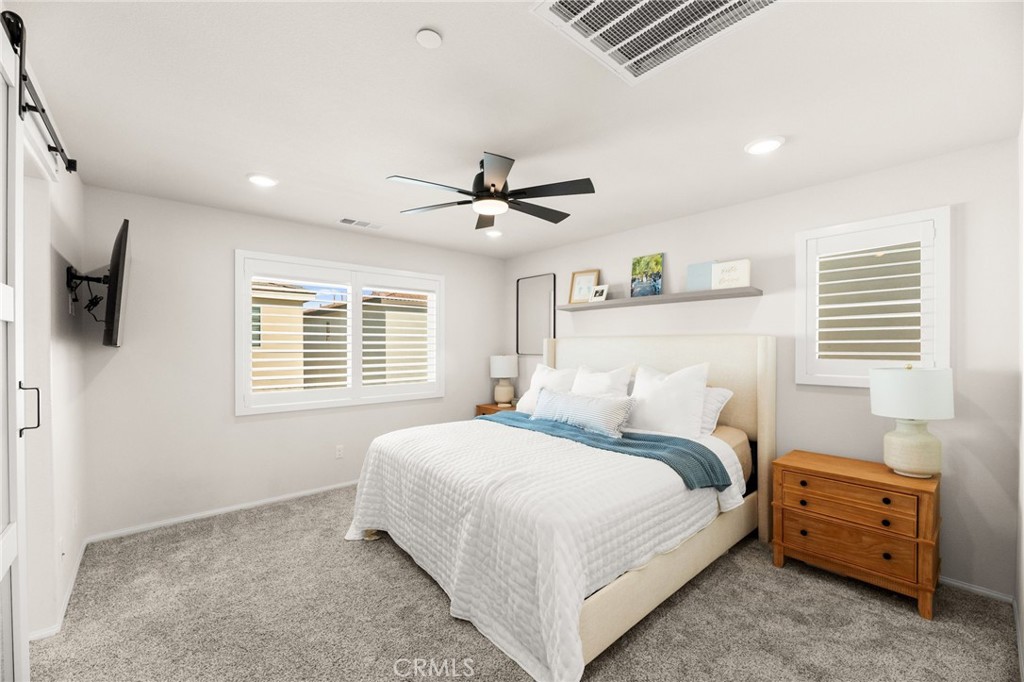 36362 Arcs Street Winchester, CA 92596 - Photo 38 of 54 a bedroom with a bed and a ceiling fan with a large window