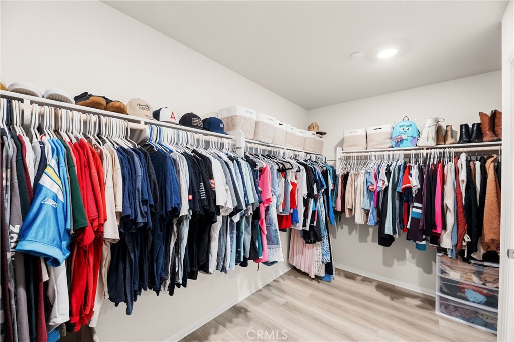 36362 Arcs Street Winchester, CA 92596 - Photo 45 of 54 a view of walk in closet with clothes
