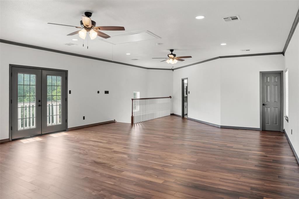 3091 Rockbridge Road McGregor, TX 76657 - Photo 34 of 40 a view of an empty room with a window and wooden floor