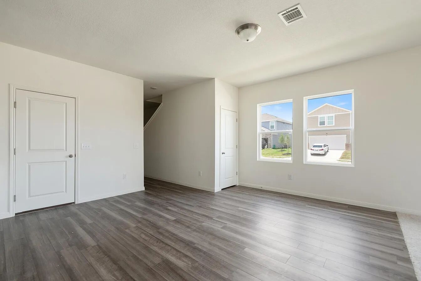 101 Aoudad Road Hutto, TX 78634 - Photo 16 of 39 A versatile living space with light wood-look flooring and naturally illuminated interiors awaits personal touches.
