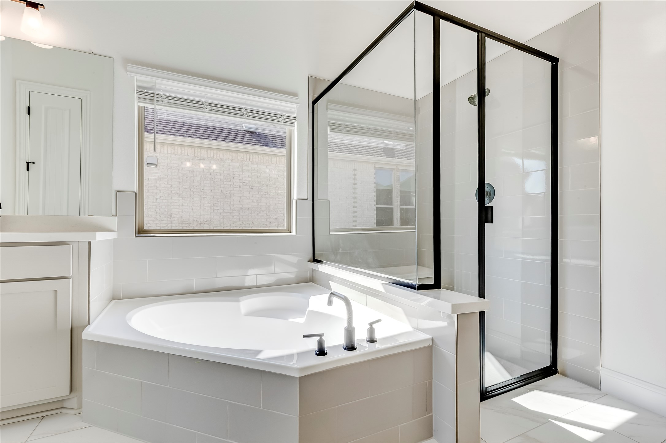 920 Old Gdn Road Leander, TX 78641 - Photo 21 of 39 Bathroom featuring a shower stall, a bath, and healthy amount of natural light