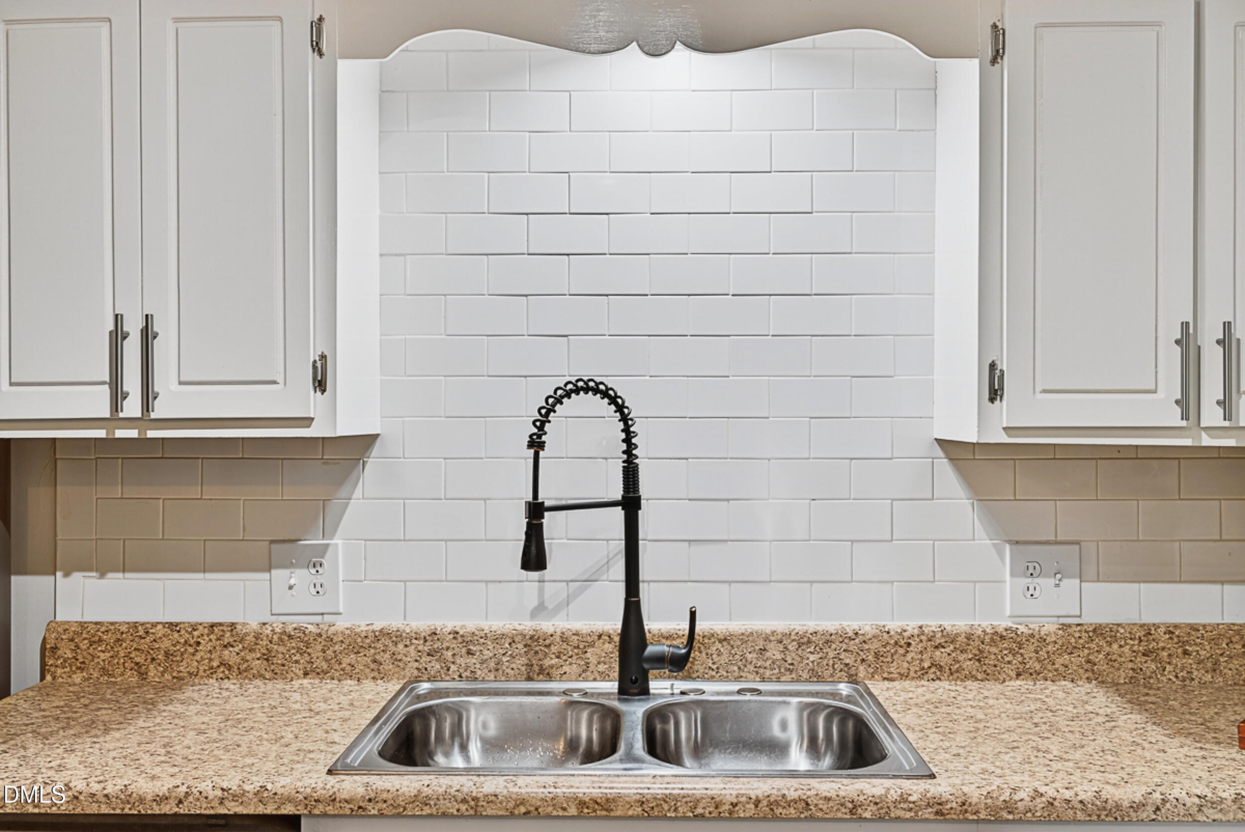 5080 Flint Ridge Place Raleigh, NC 27609 - Photo 10 of 24 a kitchen with a sink and cabinets