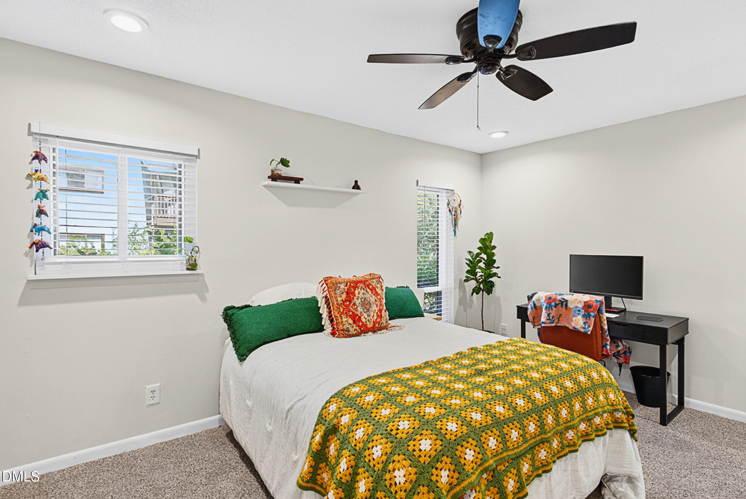 5080 Flint Ridge Place Raleigh, NC 27609 - Photo 13 of 24 a bedroom with a bed and a chandelier