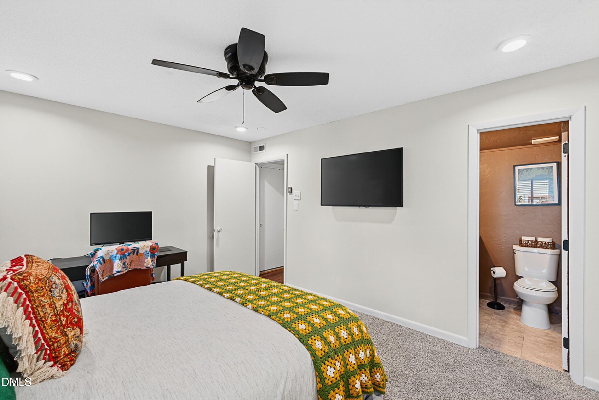 5080 Flint Ridge Place Raleigh, NC 27609 - Photo 14 of 24 a bedroom with a bed and a flat screen tv