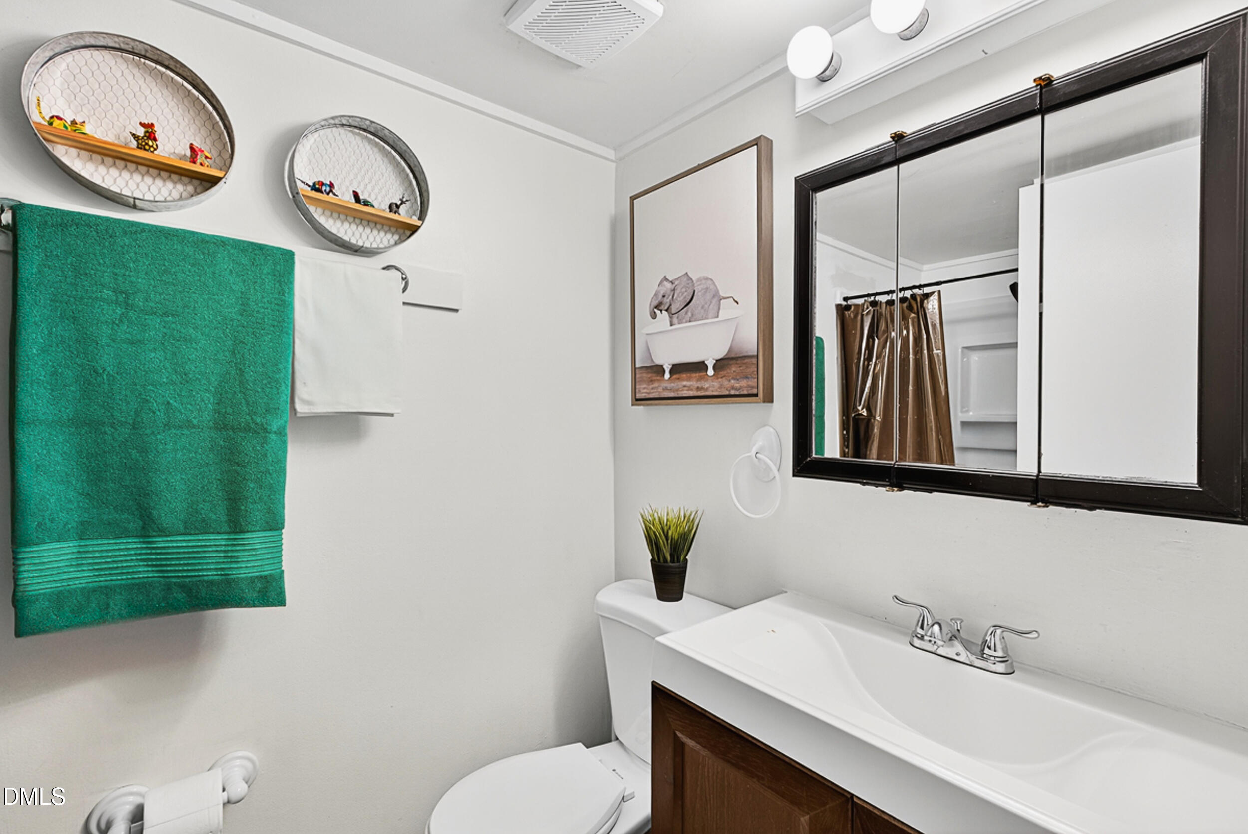 5080 Flint Ridge Place Raleigh, NC 27609 - Photo 15 of 24 a bathroom with a sink a toilet and a mirror