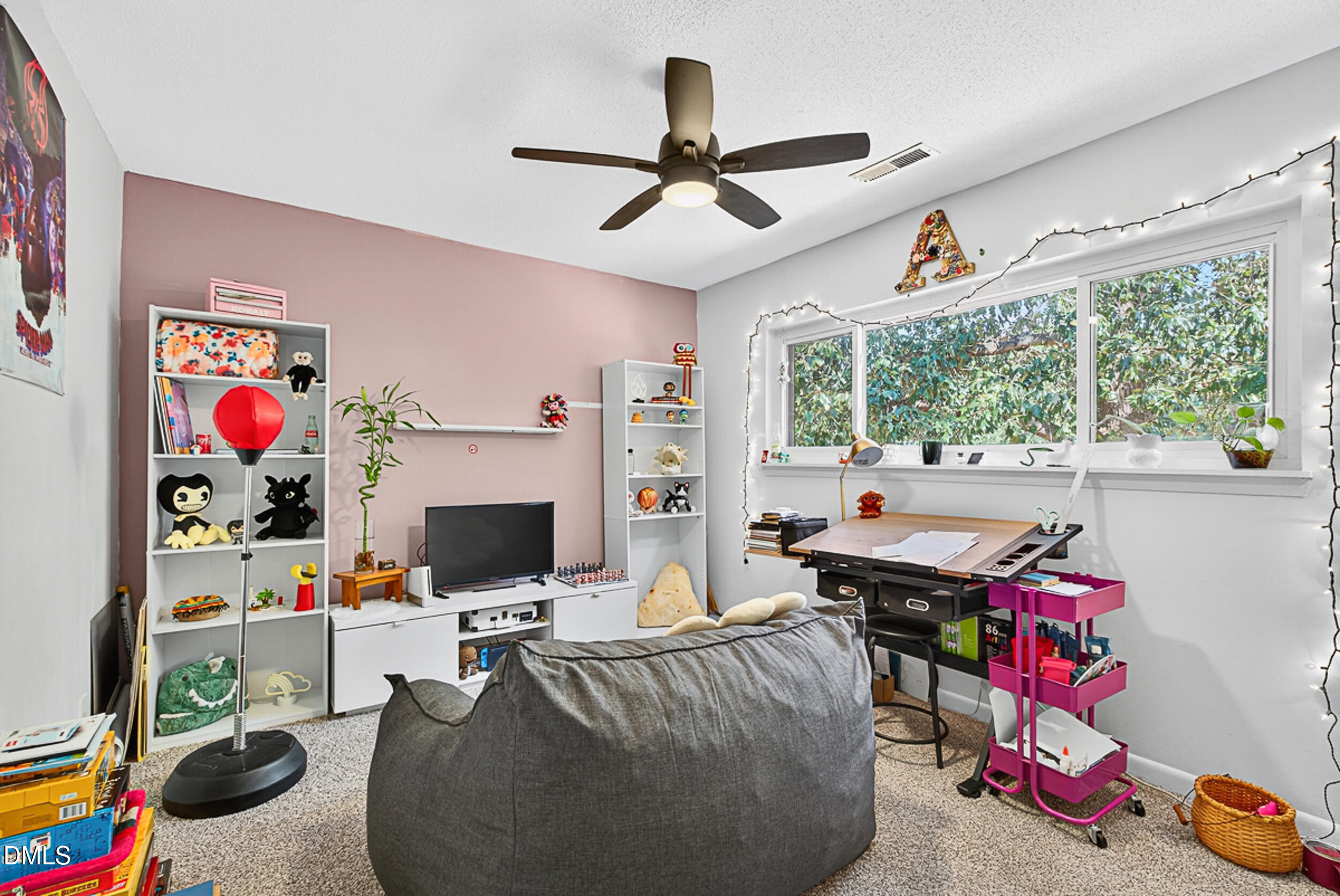 5080 Flint Ridge Place Raleigh, NC 27609 - Photo 17 of 24 a living room with furniture a flat screen tv and a floor to ceiling window