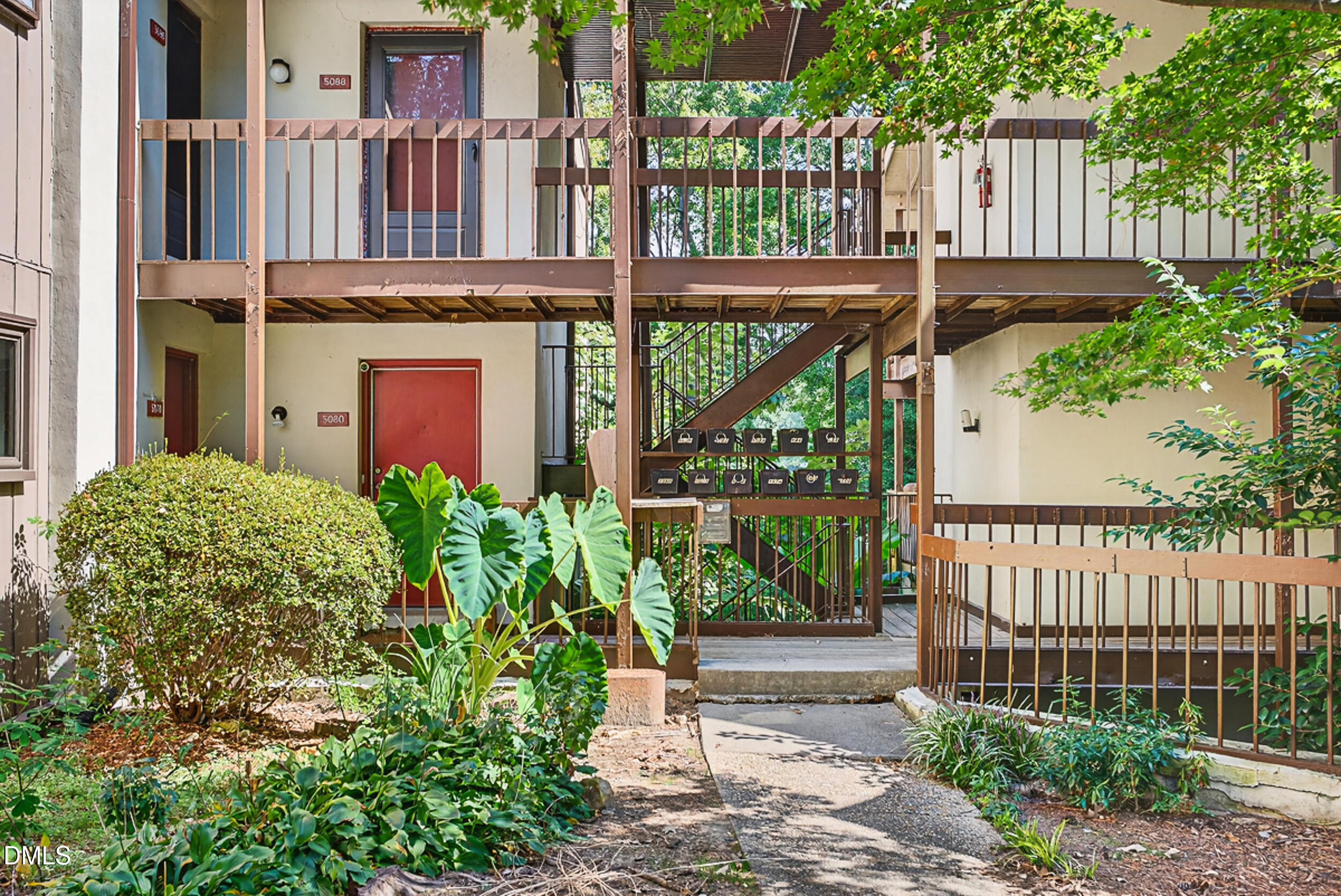 5080 Flint Ridge Place Raleigh, NC 27609 - Photo 23 of 24 a view of a house with a small yard and plants
