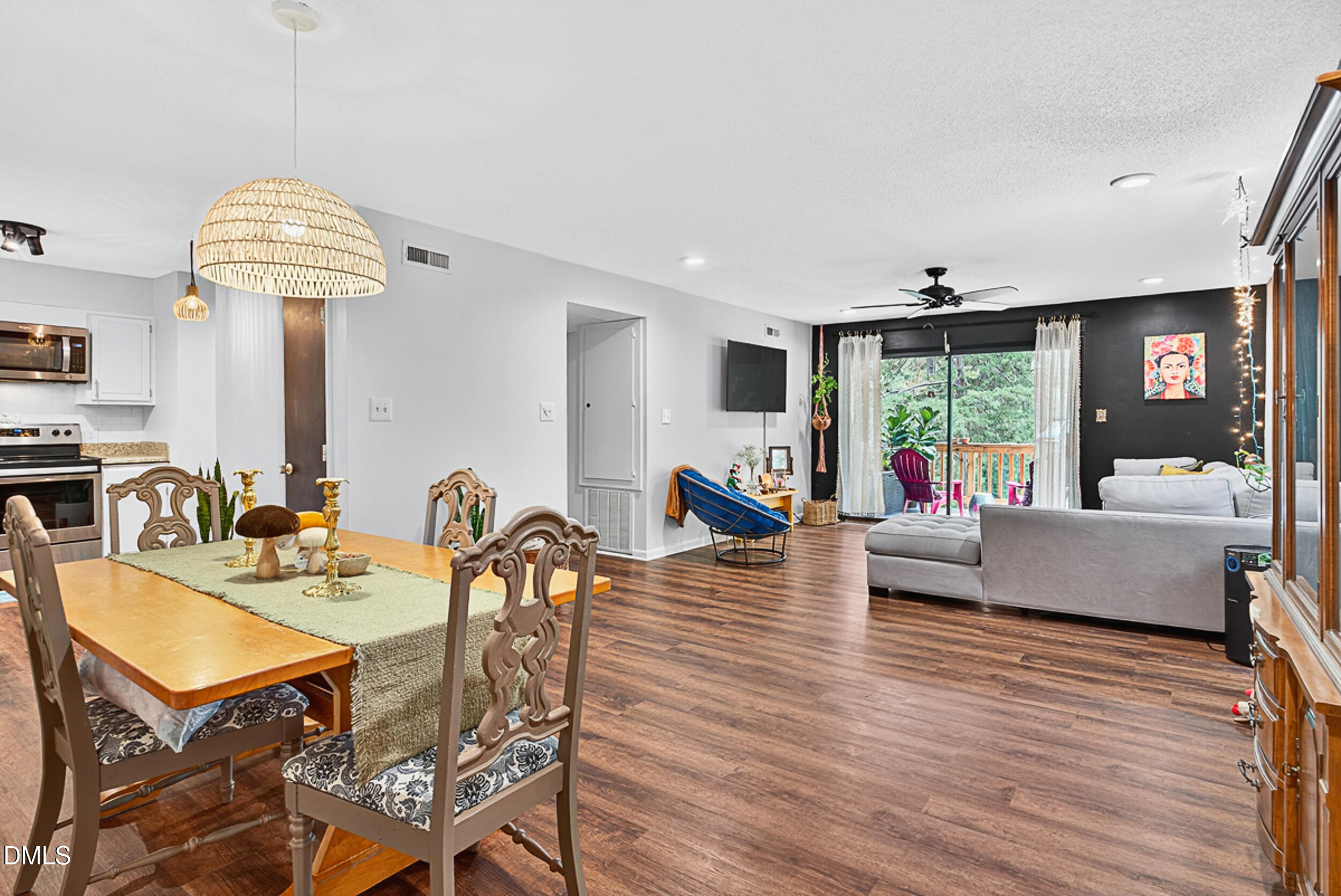 5080 Flint Ridge Place Raleigh, NC 27609 - Photo 3 of 24 a living room with dining room and wooden floor