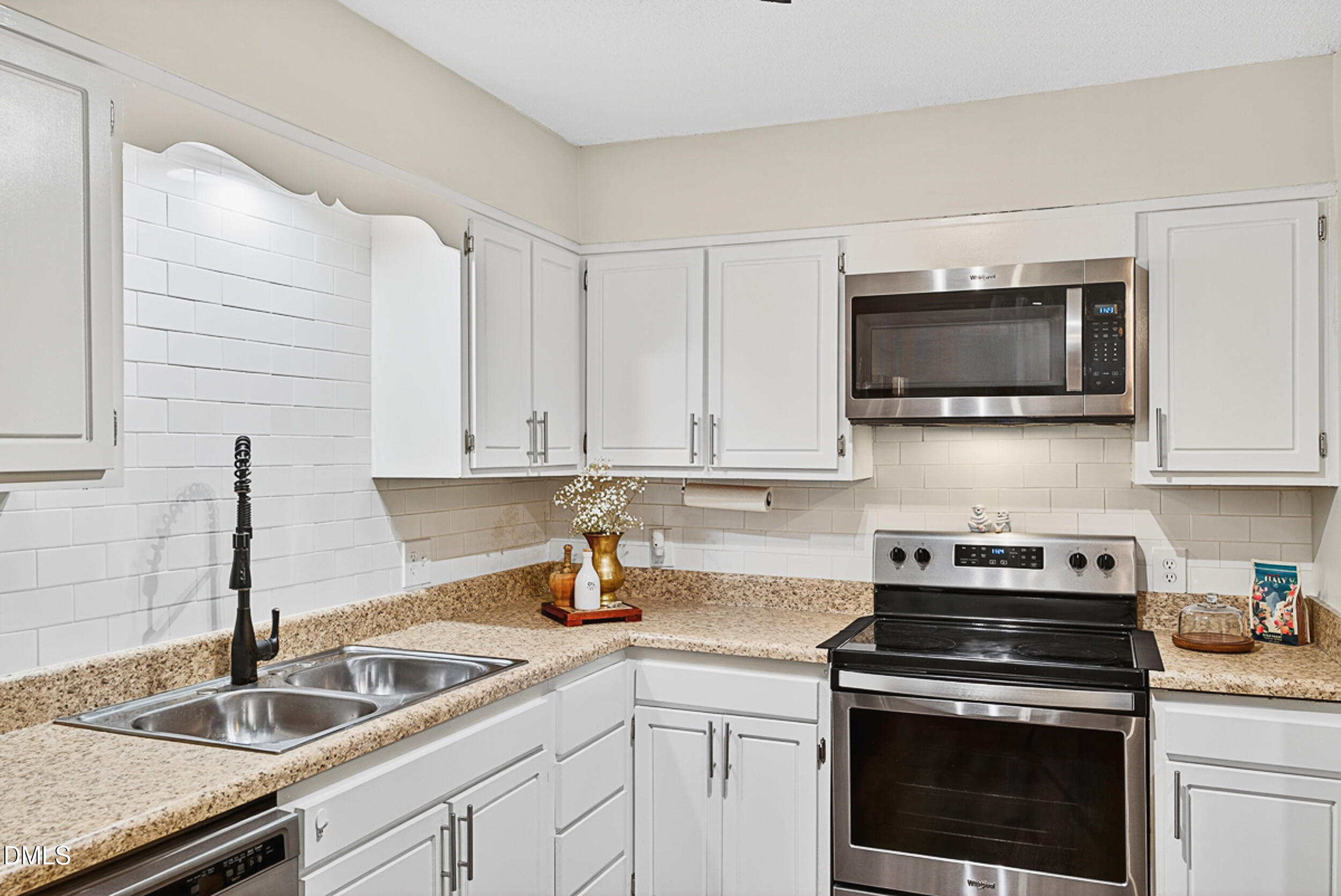 5080 Flint Ridge Place Raleigh, NC 27609 - Photo 8 of 24 a kitchen with stainless steel appliances granite countertop a sink a stove and microwave