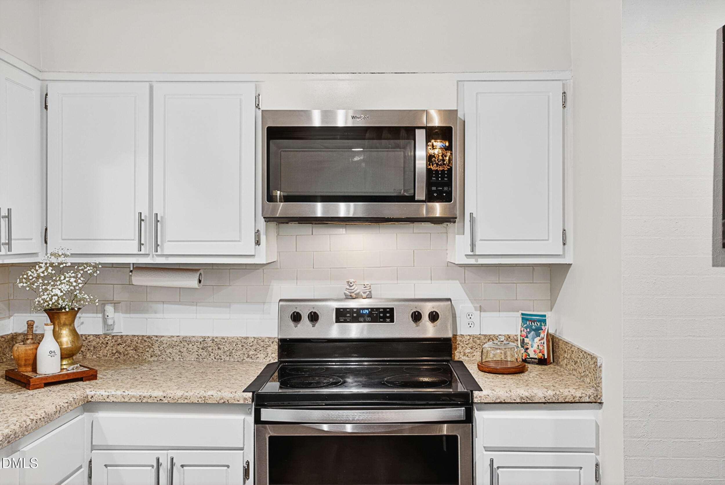 5080 Flint Ridge Place Raleigh, NC 27609 - Photo 9 of 24 a kitchen with granite countertop white cabinets and a stove top oven