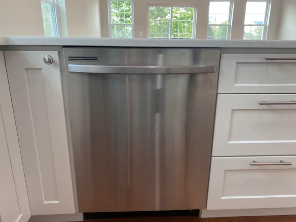 a kitchen with granite countertop a stove and a microwave