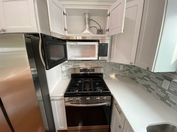 a bathroom with a glass shower door and a sink