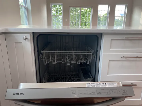 a kitchen with a sink and wooden floor