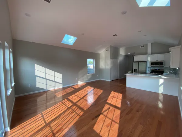 a open kitchen with stainless steel appliances kitchen island a refrigerator sink and stove