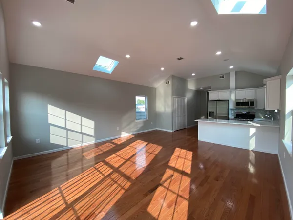 a kitchen with stainless steel appliances a refrigerator and a stove top oven