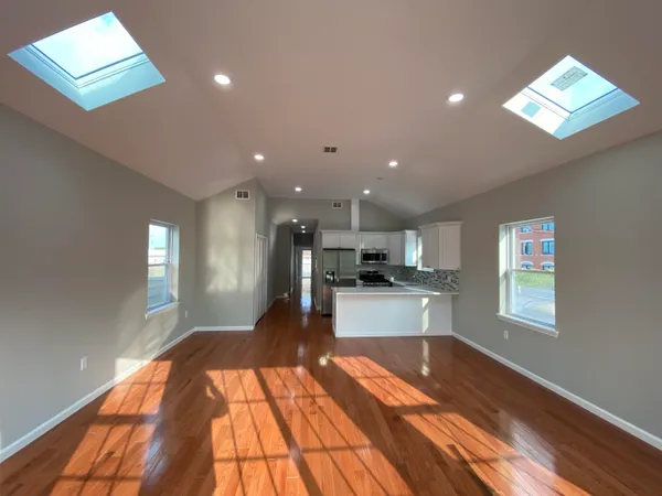 a kitchen with stainless steel appliances a refrigerator sink and microwave