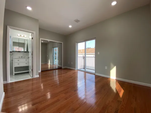 a view of a room with wooden floor and window