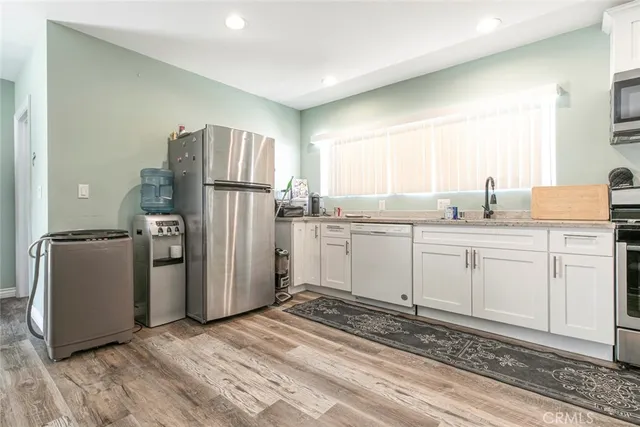 a living room with furniture window and wooden floor