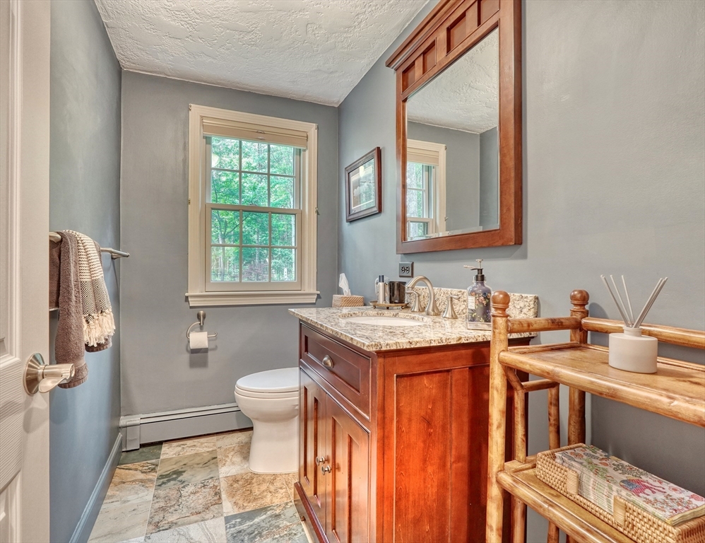 162 Border Road Concord, MA 01742 - Photo 14 of 39 a bathroom with a granite countertop sink toilet and a mirror