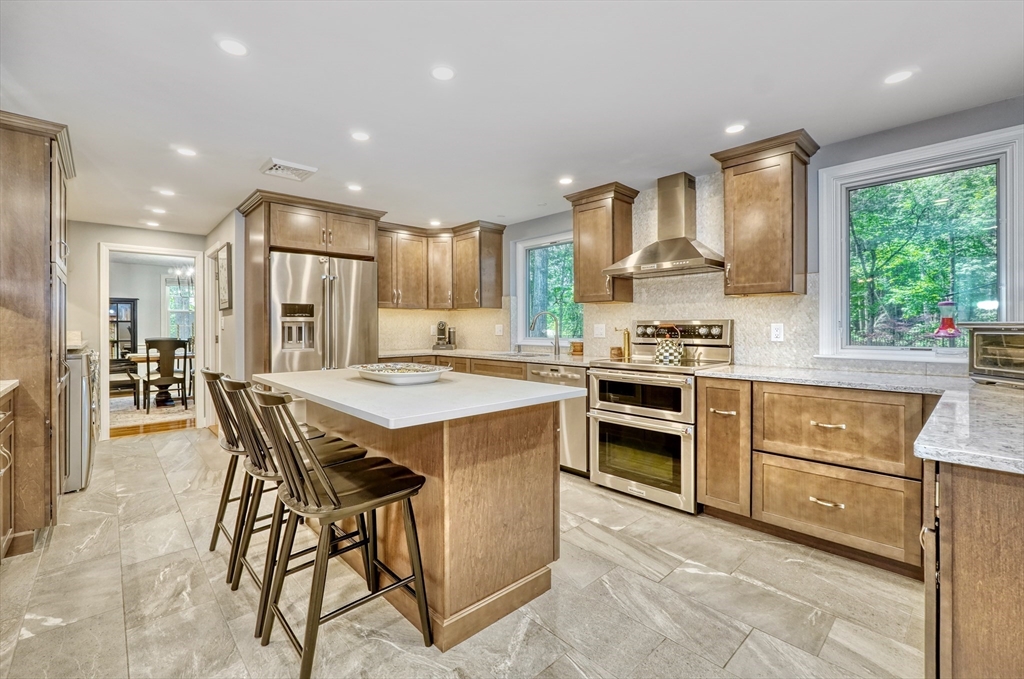 162 Border Road Concord, MA 01742 - Photo 2 of 39 a kitchen with stainless steel appliances kitchen island granite countertop a stove a sink a refrigerator and a refrigerator