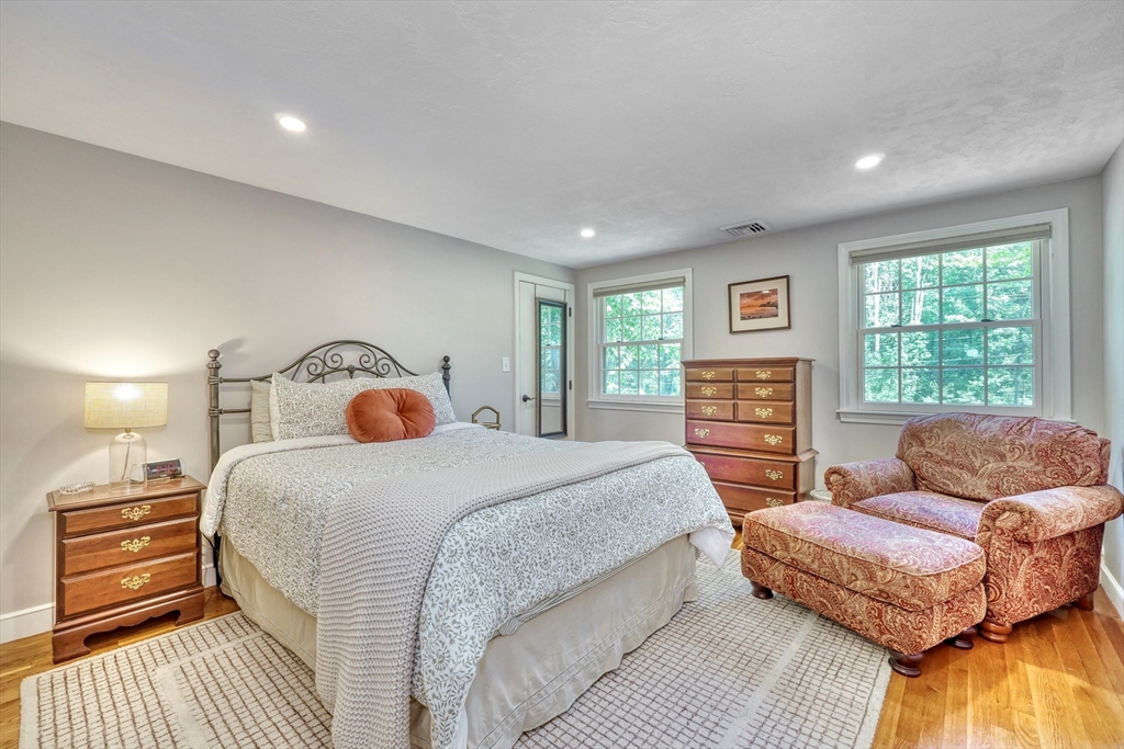 162 Border Road Concord, MA 01742 - Photo 23 of 39 a spacious bedroom with a bed and wooden floor