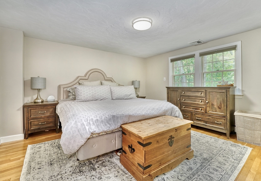 162 Border Road Concord, MA 01742 - Photo 3 of 39 a bedroom with a bed and wooden floor