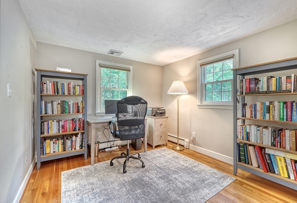 162 Border Road Concord, MA 01742 - Photo 34 of 39 a living room with a book shelf and a book shelf
